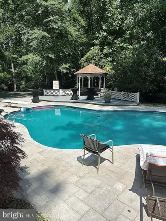 a view of a house with swimming pool and a yard