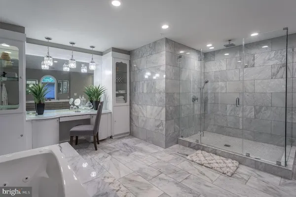 a bathroom with a bathtub shower sink and mirror