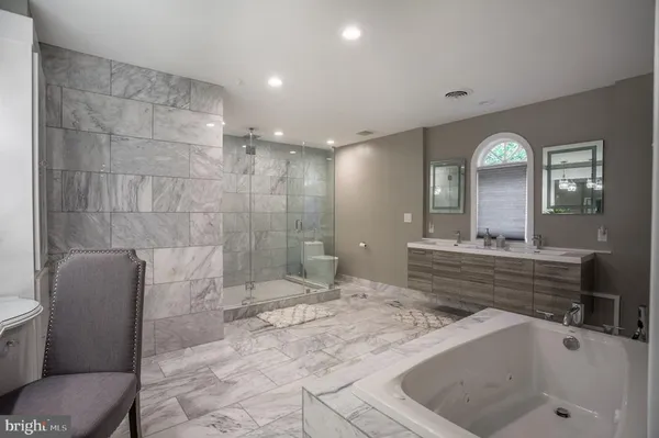 a bathroom with a sink mirror toilet and bathtub