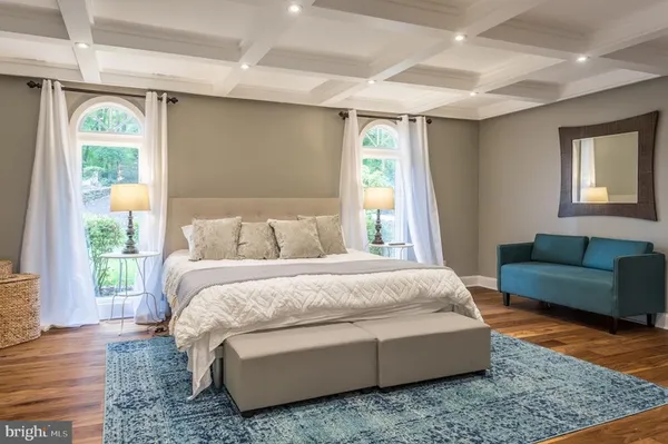 a bedroom with a bed couch and a window