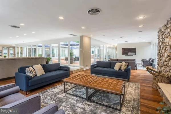 a living room with furniture wooden floor and a table