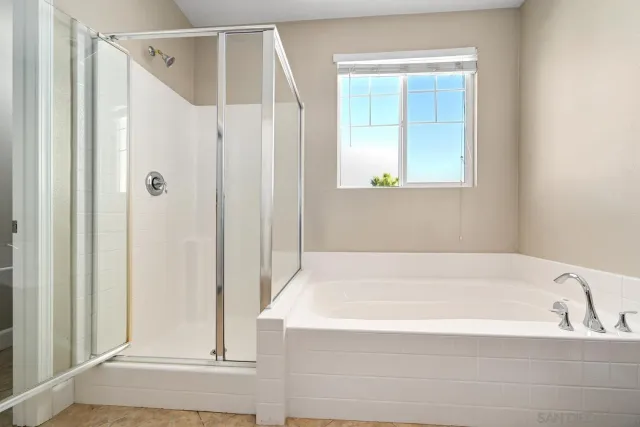 a bathroom with a bathtub and a shower