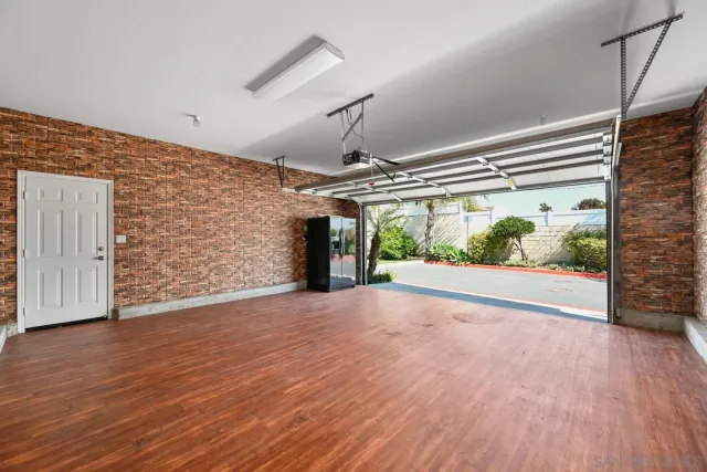 a view of a room with wooden floor and large window