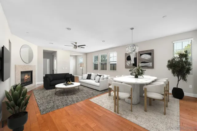 a living room with furniture potted plant a fireplace and a window