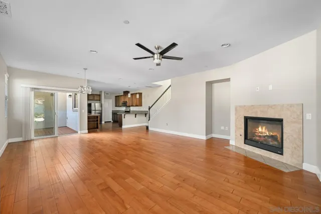 a view of empty room with a fireplace and wooden floor
