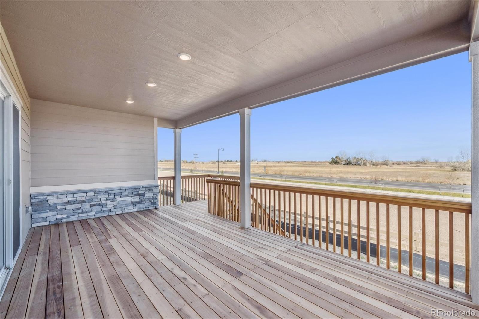 1180 Weller Street Timnath, CO 80547 - Photo 12 of 26 a view of a balcony with wooden floor