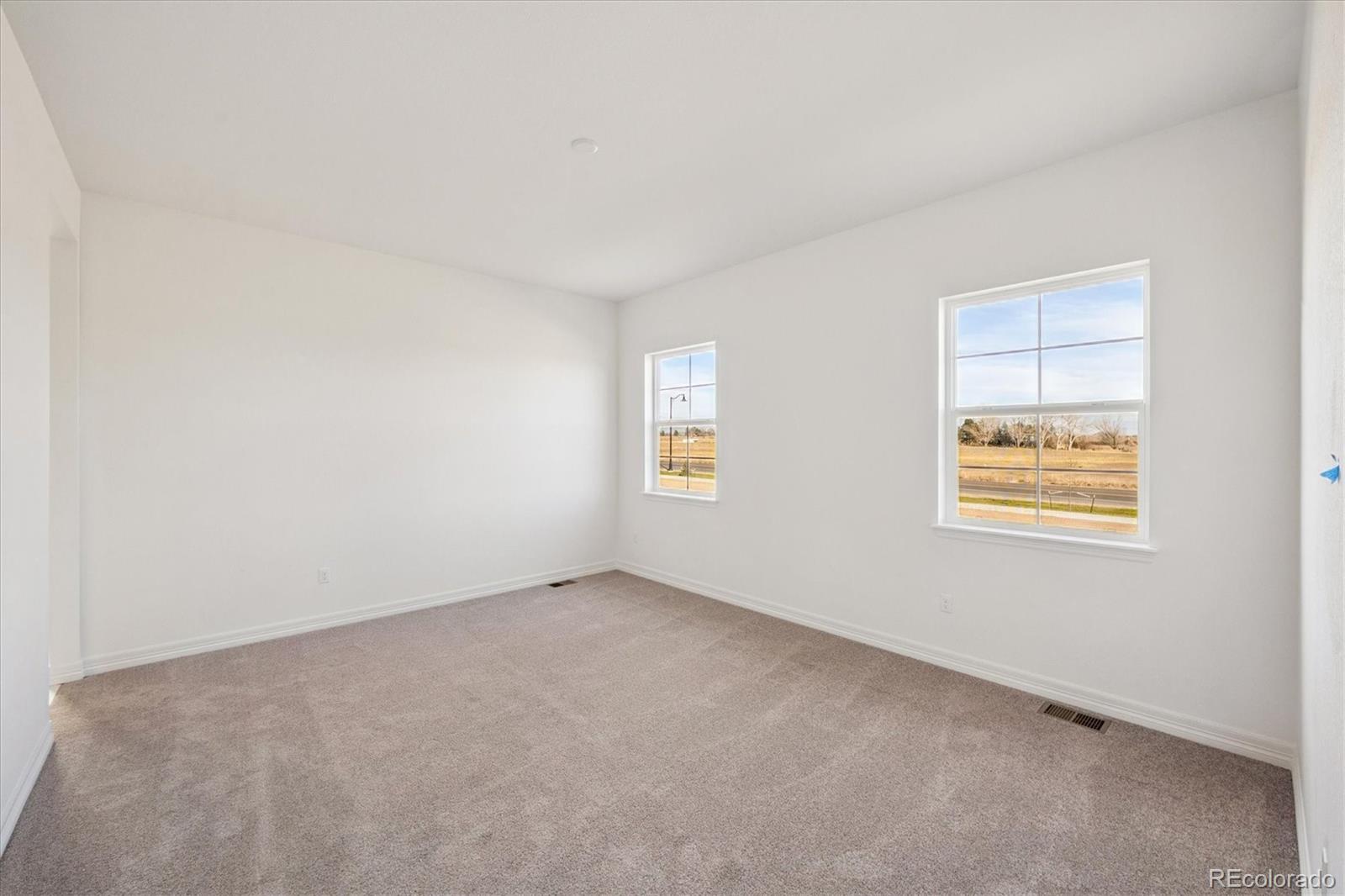 1180 Weller Street Timnath, CO 80547 - Photo 13 of 26 an empty room with windows