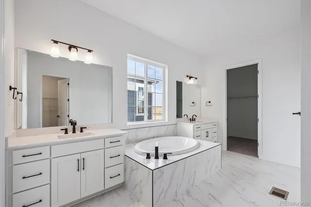 a bathroom with a granite countertop sink mirror bathtub and shower