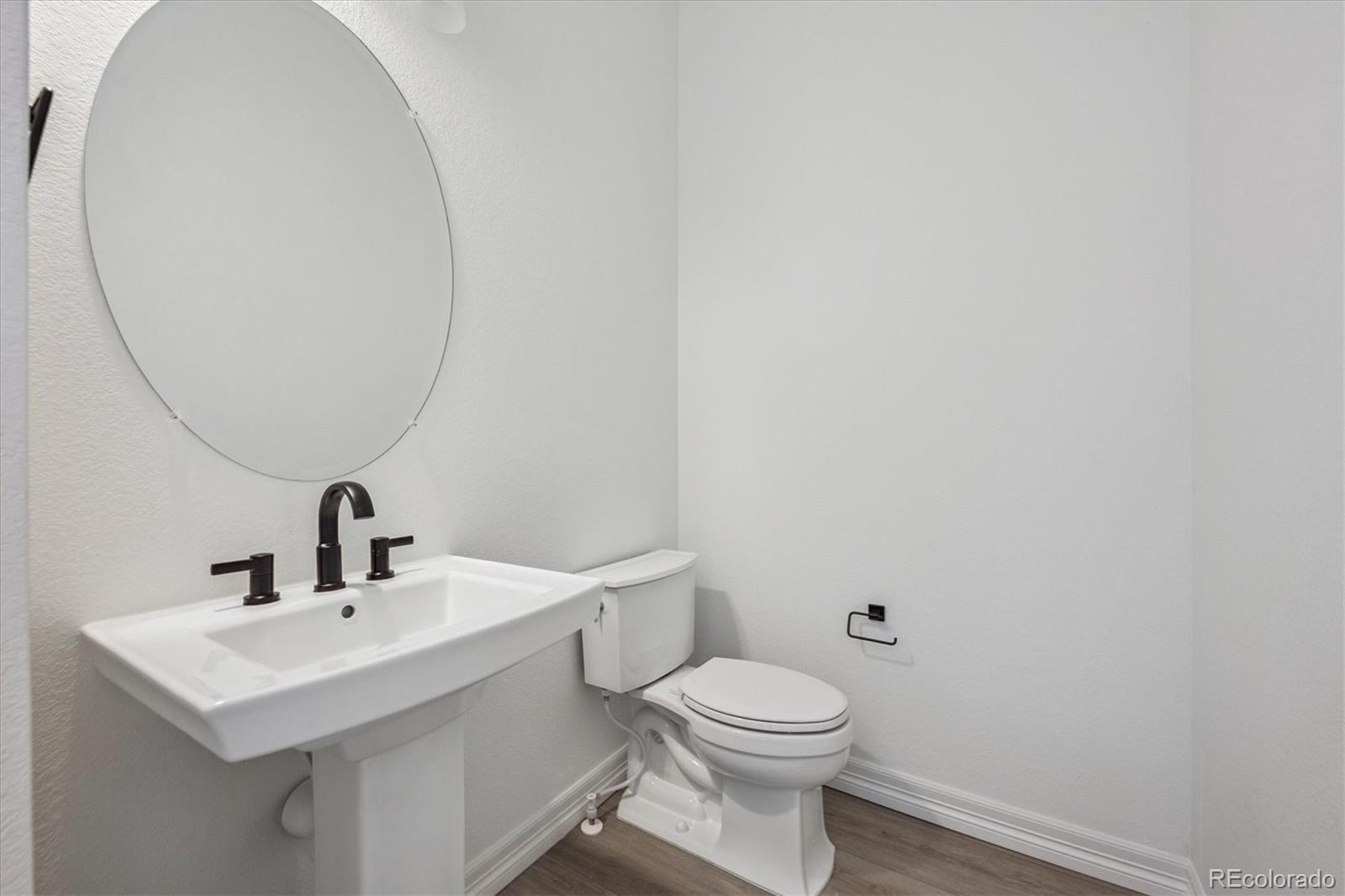 1180 Weller Street Timnath, CO 80547 - Photo 16 of 26 a bathroom with a toilet a sink and mirror