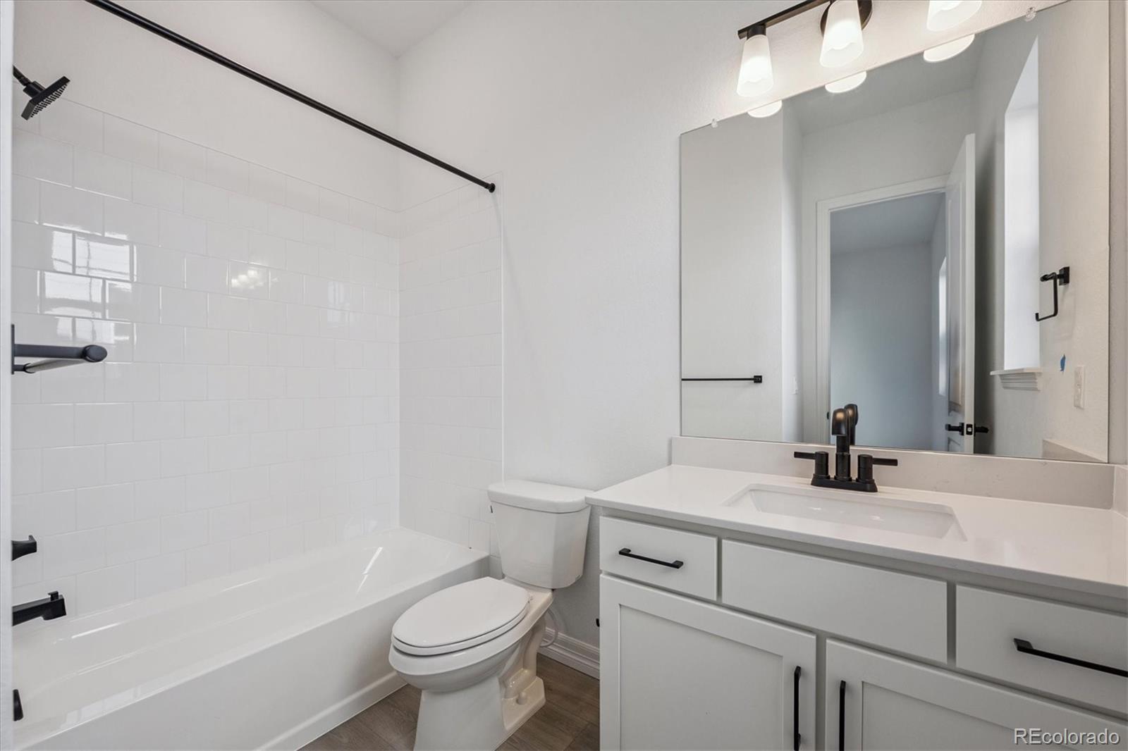 1180 Weller Street Timnath, CO 80547 - Photo 19 of 26 a bathroom with a sink a toilet and shower