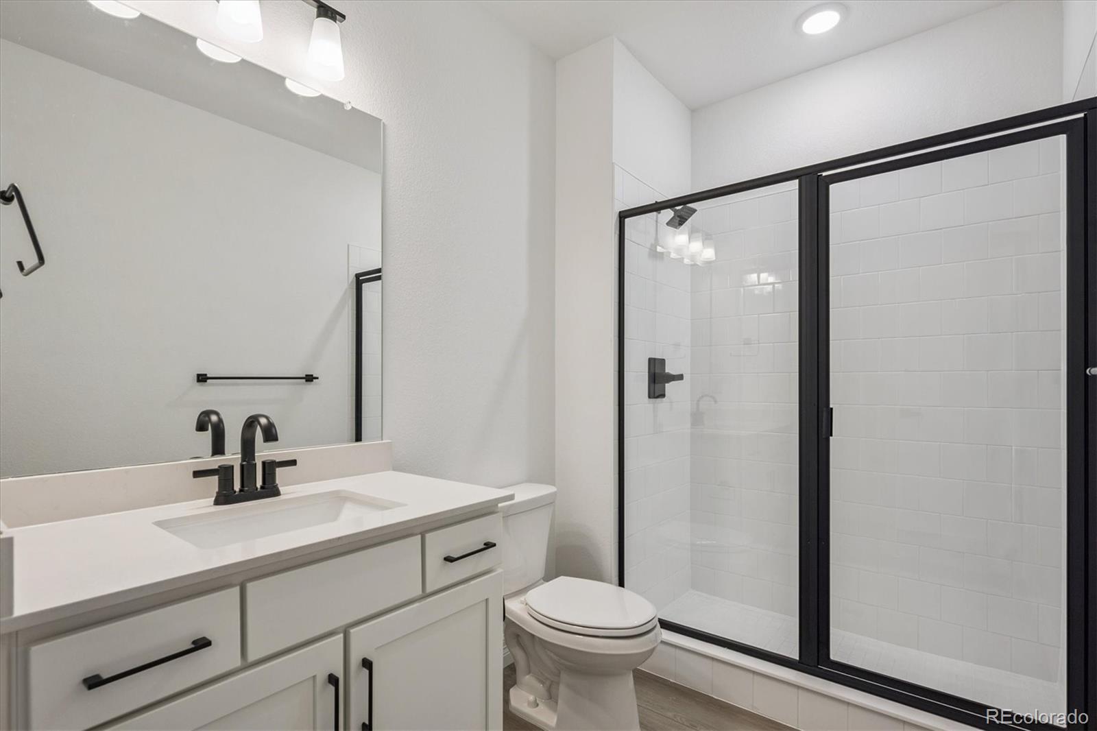 1180 Weller Street Timnath, CO 80547 - Photo 22 of 26 a bathroom with a sink toilet and shower