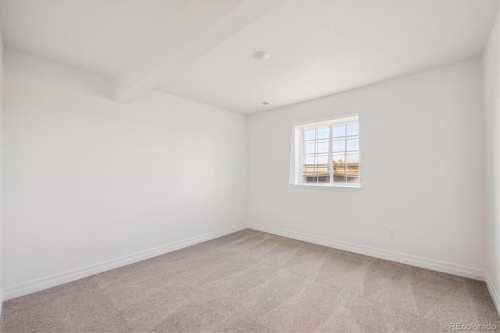 1180 Weller Street Timnath, CO 80547 - Photo 23 of 26 an empty room with a window