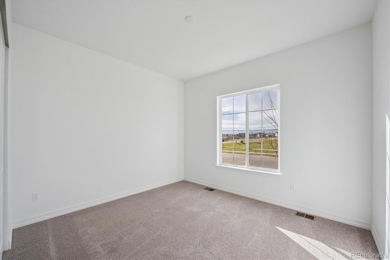 1180 Weller Street Timnath, CO 80547 - Photo 3 of 26 an empty room with a window