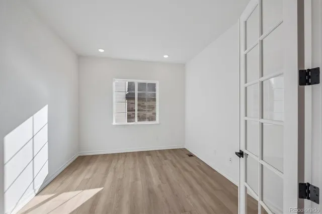 a view of a room with wooden floor and window