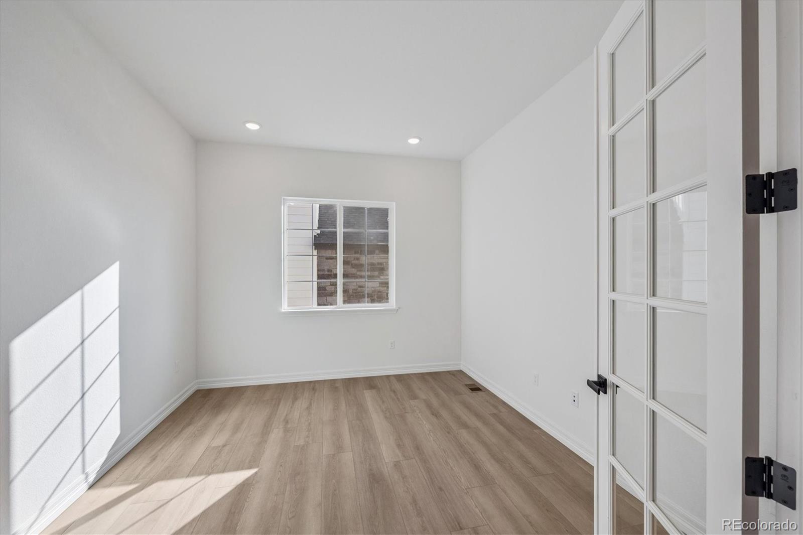 1180 Weller Street Timnath, CO 80547 - Photo 4 of 26 a view of a room with wooden floor and window