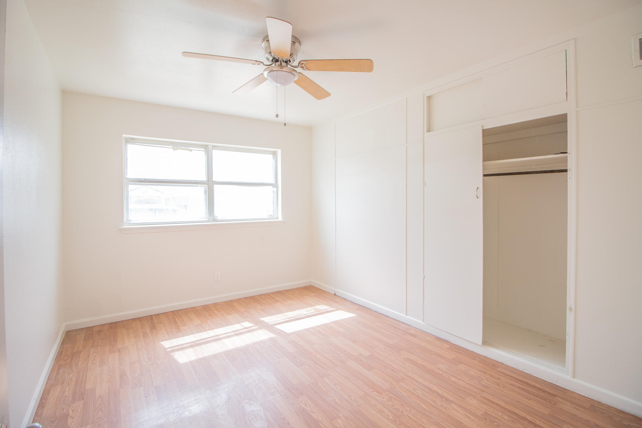 3304 Itasca Street Lubbock, TX 79415 - Photo 11 of 18 a view of an empty room with wooden floor and a window