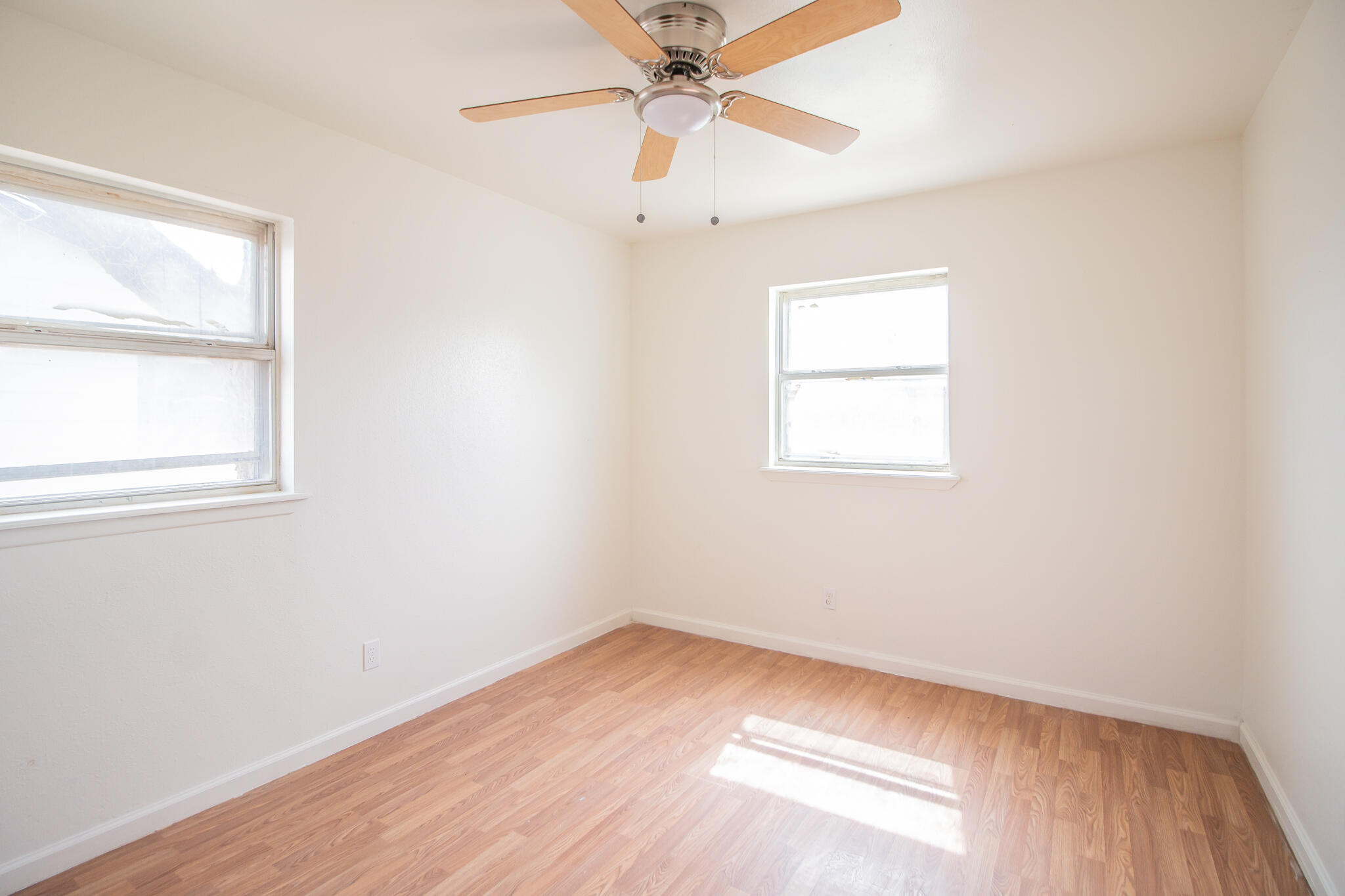 3304 Itasca Street Lubbock, TX 79415 - Photo 12 of 18 an empty room with a window and a ceiling fan