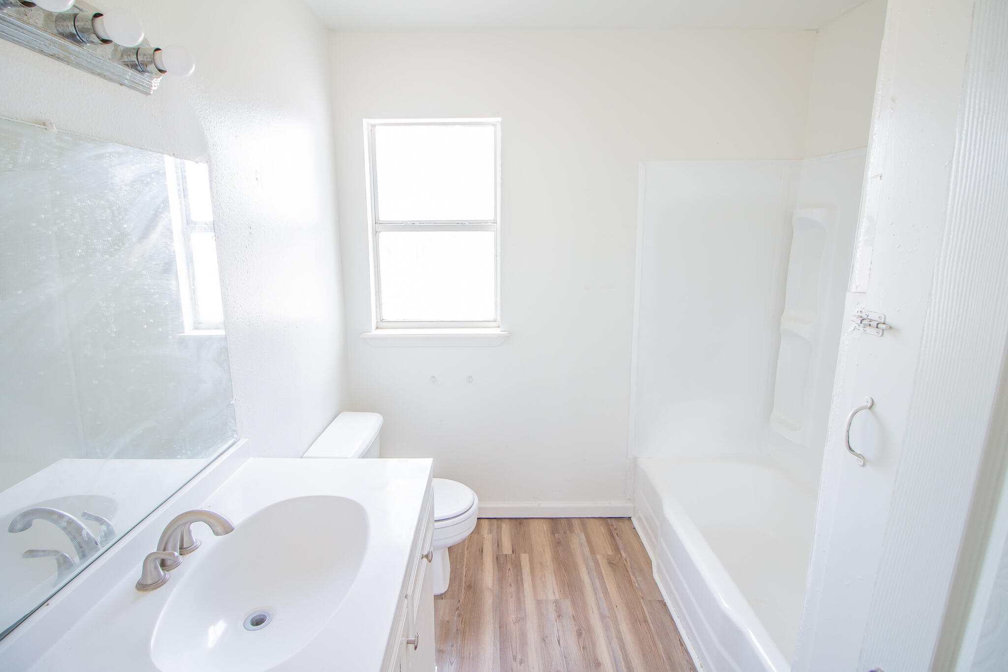 3304 Itasca Street Lubbock, TX 79415 - Photo 14 of 18 a bathroom with a sink and a bathtub