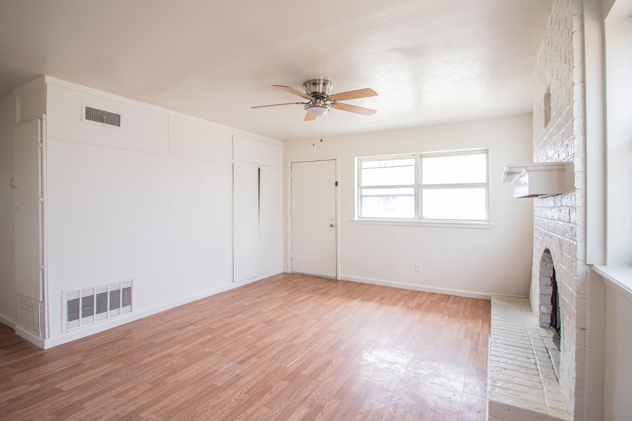 3304 Itasca Street Lubbock, TX 79415 - Photo 5 of 18 a view of an empty room with a window and wooden floor