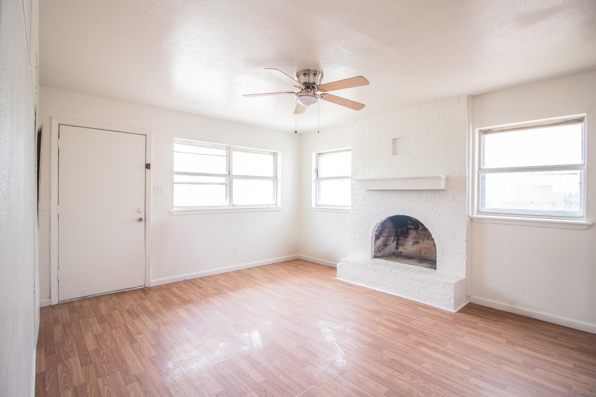 3304 Itasca Street Lubbock, TX 79415 - Photo 6 of 18 an empty room with windows and fireplace