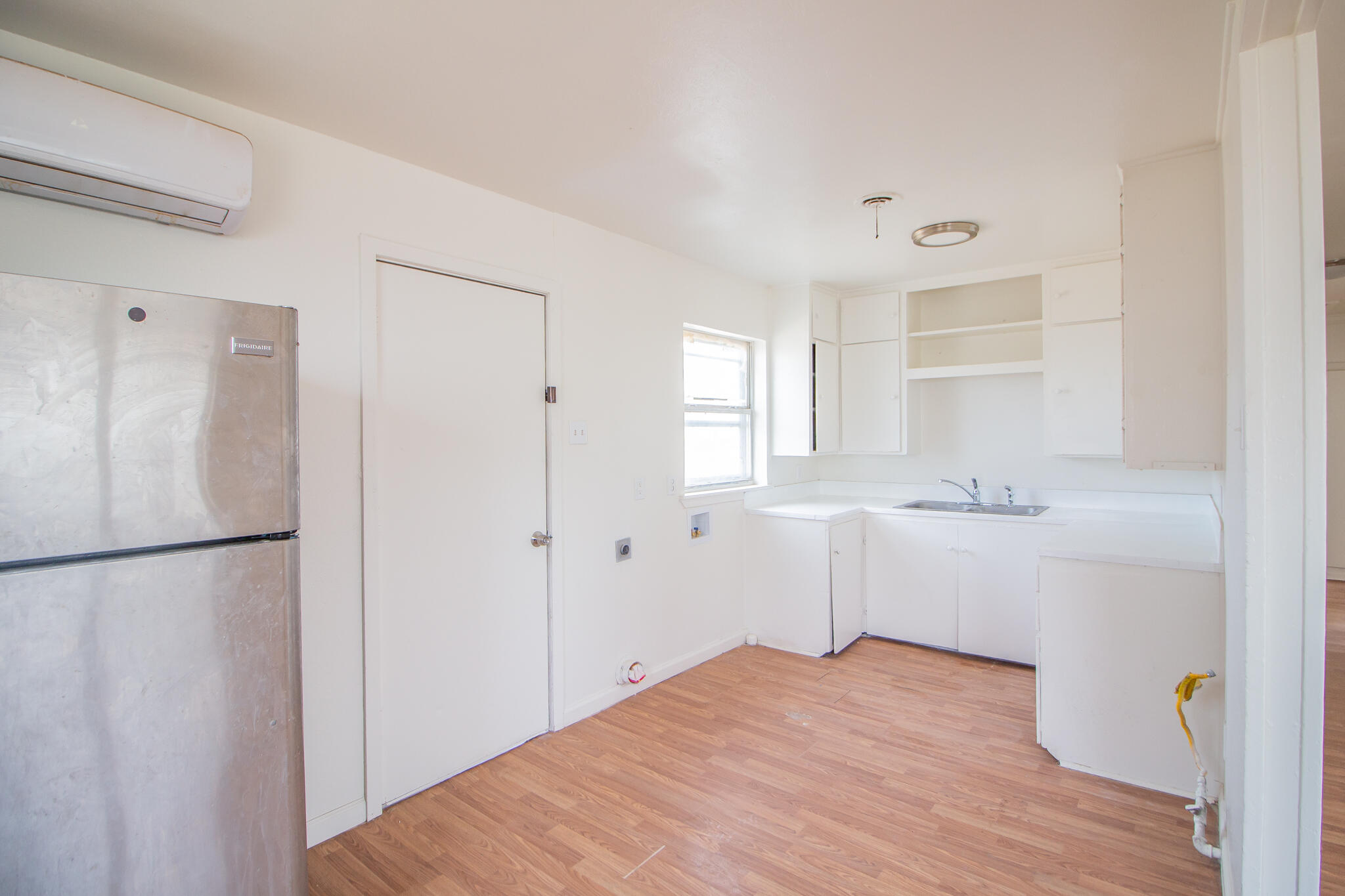3304 Itasca Street Lubbock, TX 79415 - Photo 7 of 18 a kitchen with a refrigerator a sink and cabinets