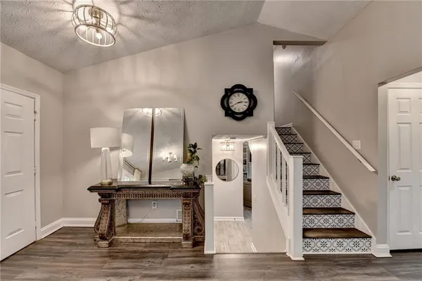 a view of entryway with a table and a clock