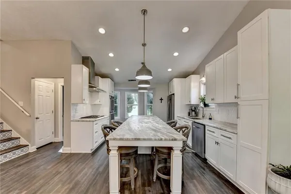 a dining room with furniture and wooden floor