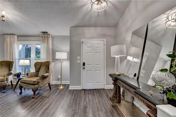 a kitchen with stainless steel appliances a kitchen island hardwood floor sink stove dining table and chairs