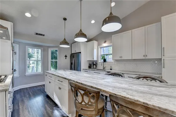 a stove top oven sitting inside of a kitchen