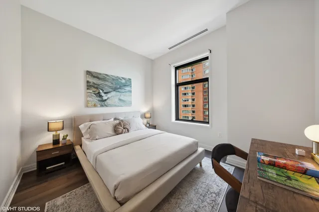 a bedroom with a bed and a table in it