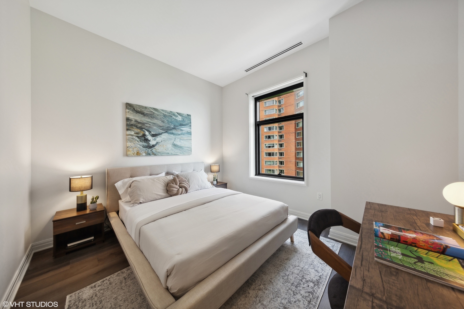 61 East Banks Street, Unit 802 Chicago, IL 60610 - Photo 12 of 23 a bedroom with a bed and a table in it