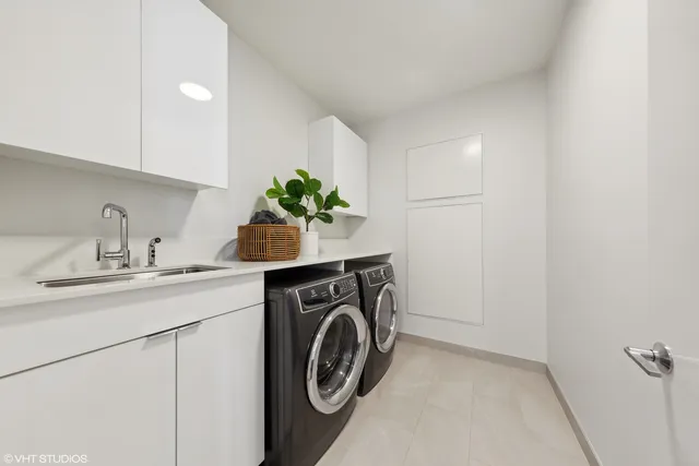 a utility room with sink dryer and washer