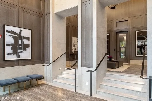 a view of entryway and hall with wooden floor