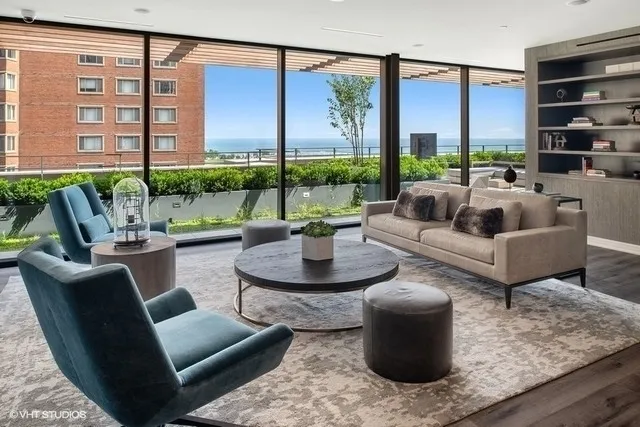 a living room with patio furniture and a potted plant