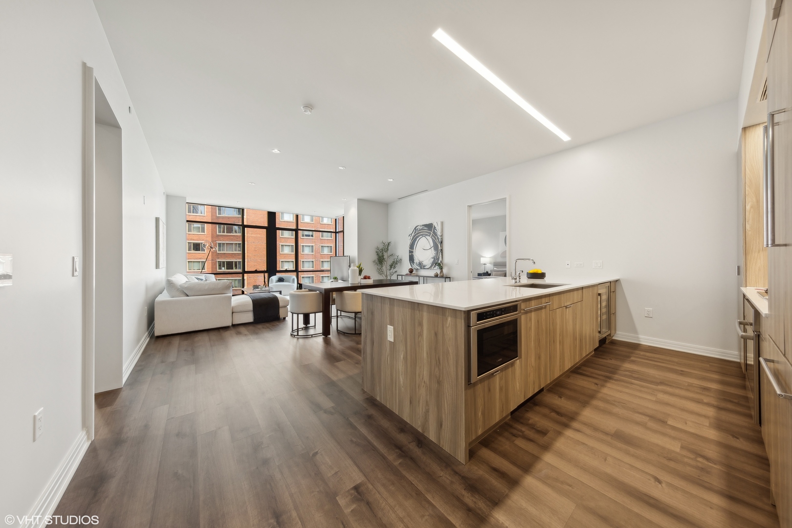 61 East Banks Street, Unit 802 Chicago, IL 60610 - Photo 2 of 23 a kitchen with stainless steel appliances a white stove top oven a sink and dishwasher with wooden floor