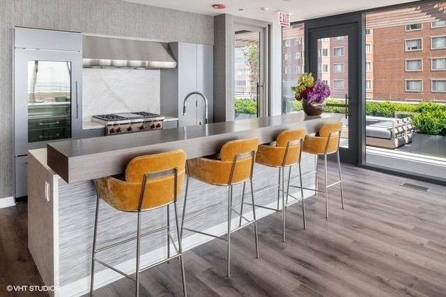 61 East Banks Street, Unit 802 Chicago, IL 60610 - Photo 21 of 23 a view of a dining room with furniture window and wooden floor