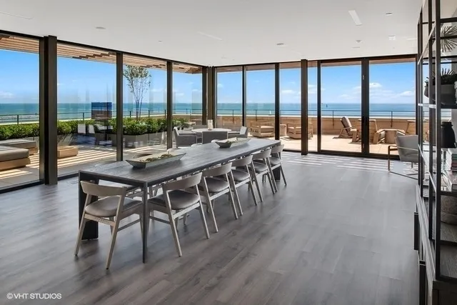 a dining room with furniture window and wooden floor