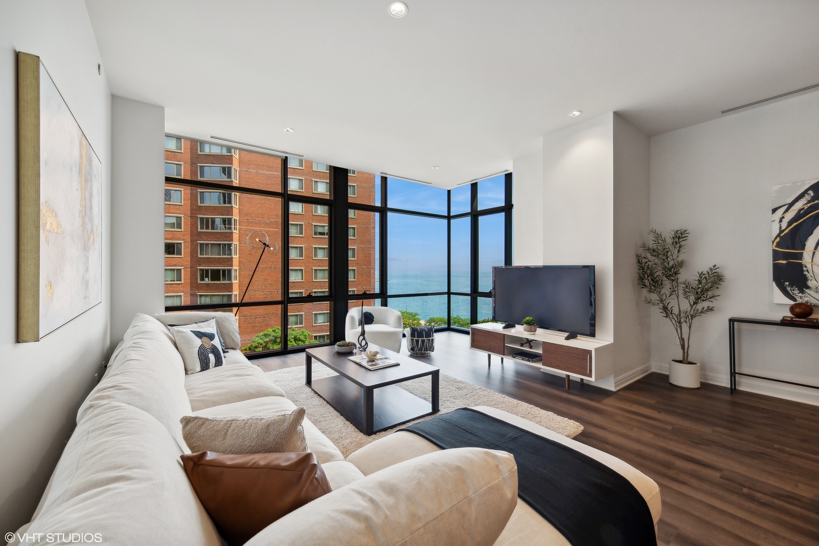 61 East Banks Street, Unit 802 Chicago, IL 60610 - Photo 3 of 23 a living room with furniture tv and a large window