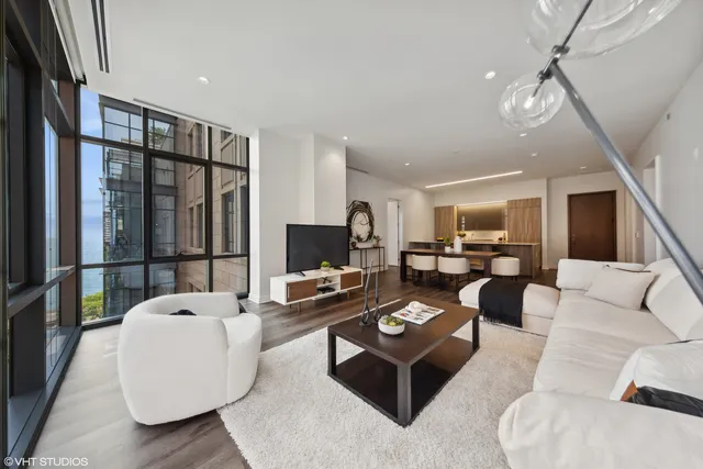 a living room with furniture a flat screen tv and a large window