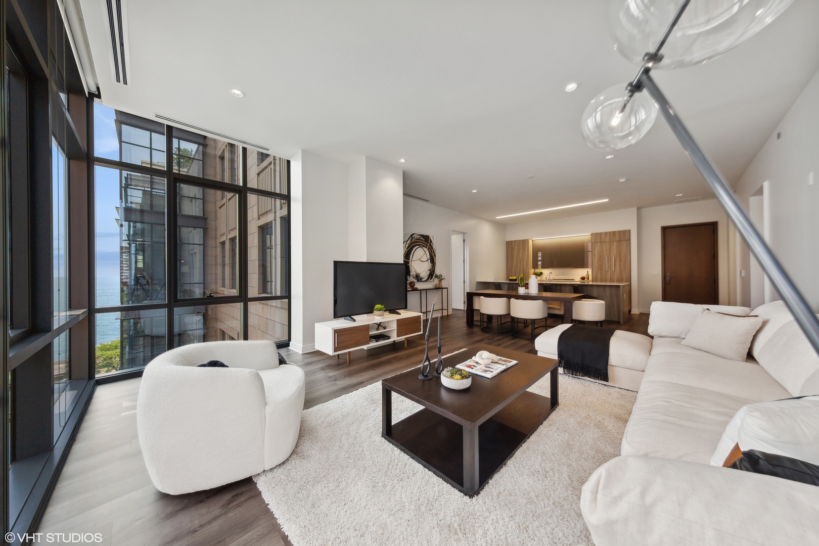 61 East Banks Street, Unit 802 Chicago, IL 60610 - Photo 5 of 23 a living room with furniture a flat screen tv and a large window