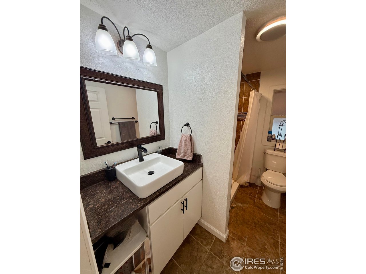 9775 Lark Street Federal Heights, CO 80260 - Photo 14 of 17 a bathroom with a sink and a mirror