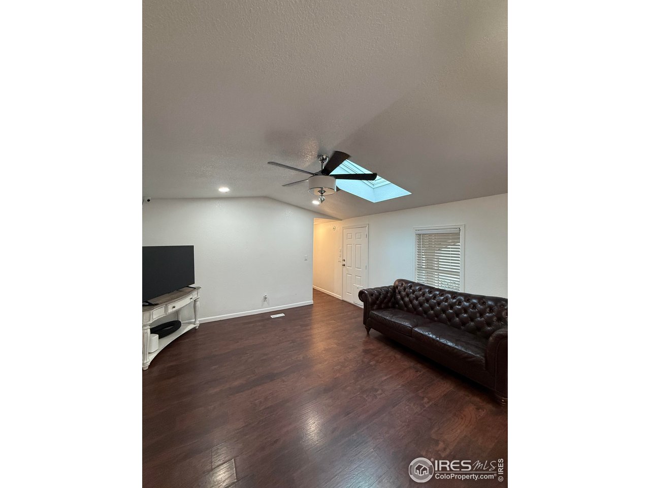 9775 Lark Street Federal Heights, CO 80260 - Photo 7 of 17 a living room with furniture and a flat screen tv