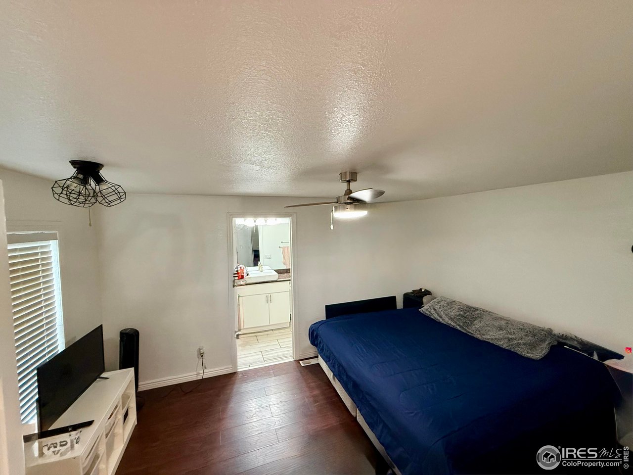 9775 Lark Street Federal Heights, CO 80260 - Photo 8 of 17 a bedroom with a bed and wooden floor