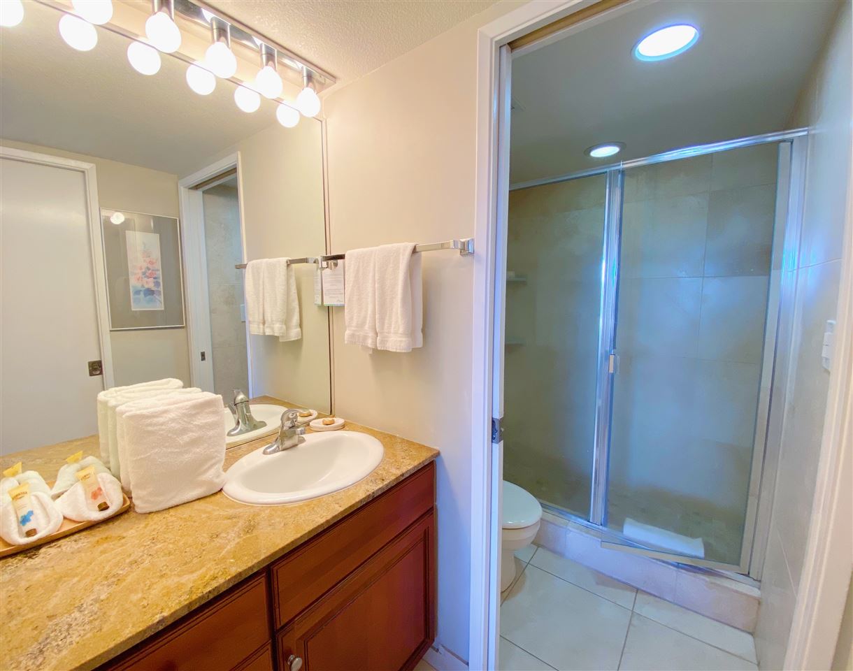 2575 South Kihei Road, Unit Q401/401A Kihei, HI 96753 - Photo 13 of 25 a bathroom with a granite countertop sink a toilet and shower