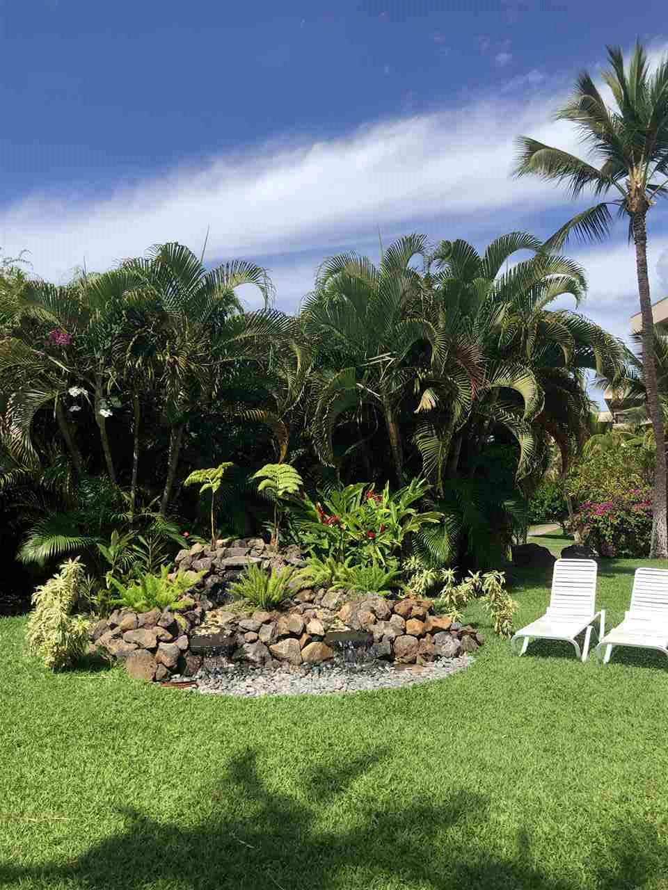 2575 South Kihei Road, Unit Q401/401A Kihei, HI 96753 - Photo 19 of 25 a backyard of a house with lots of green space and garden