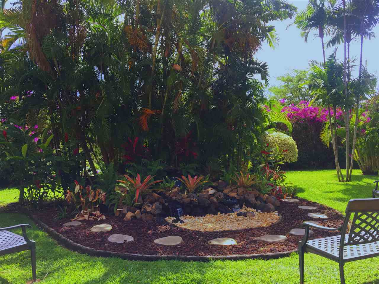 2575 South Kihei Road, Unit Q401/401A Kihei, HI 96753 - Photo 20 of 25 a view of a backyard with plants and a patio