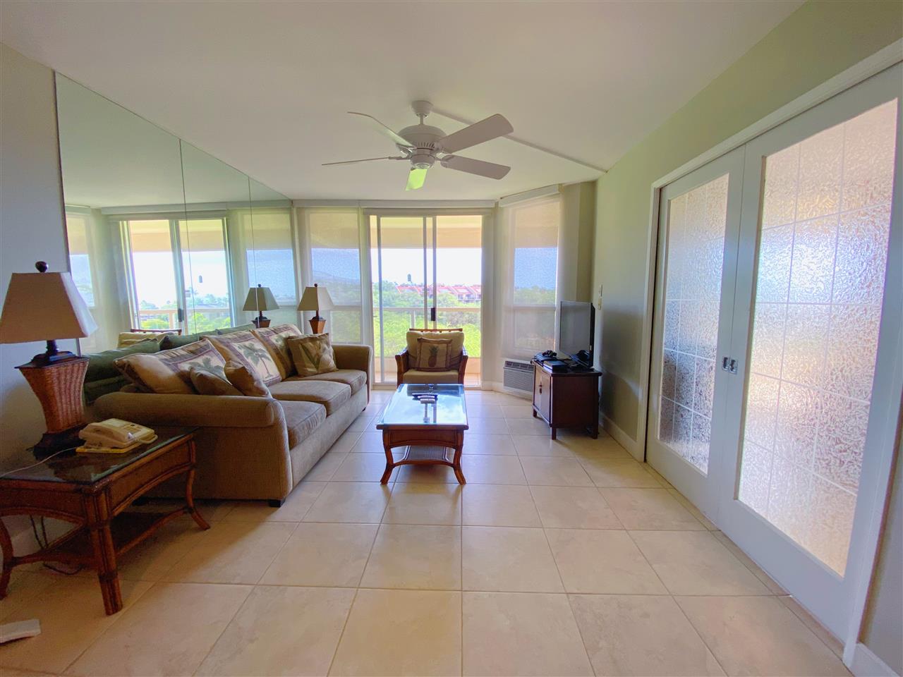 2575 South Kihei Road, Unit Q401/401A Kihei, HI 96753 - Photo 6 of 25 a living room with furniture and large windows