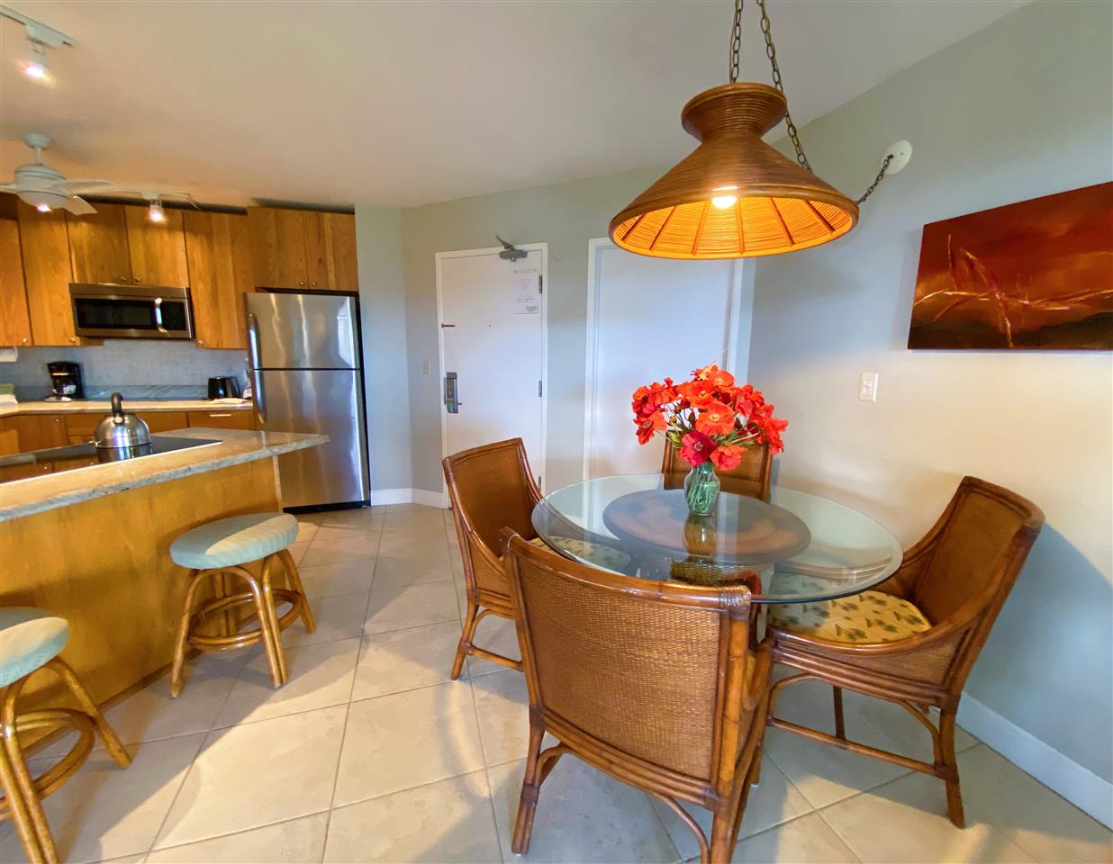 2575 South Kihei Road, Unit Q401/401A Kihei, HI 96753 - Photo 8 of 25 a dining room with furniture a chandelier and kitchen view