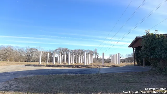 a view of a yard with lawn chairs