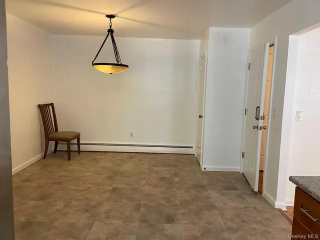 a view of a room with a table and a chair